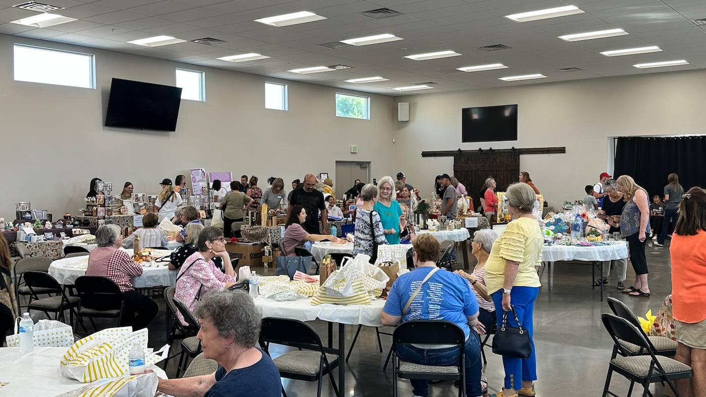 New Hope adults visiting around tables in the fellowship hall