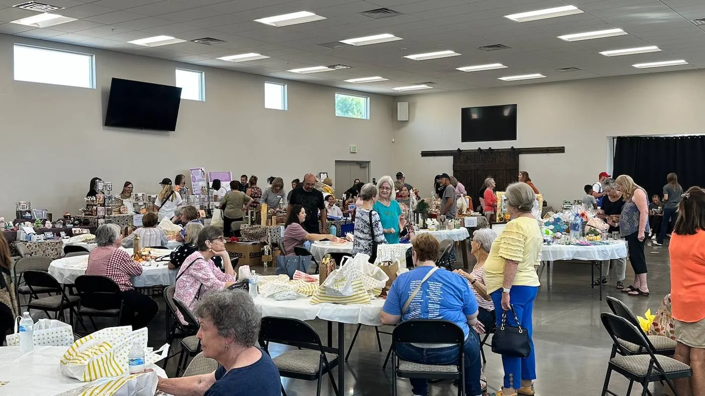 New Hope adults visiting around tables in the fellowship hall