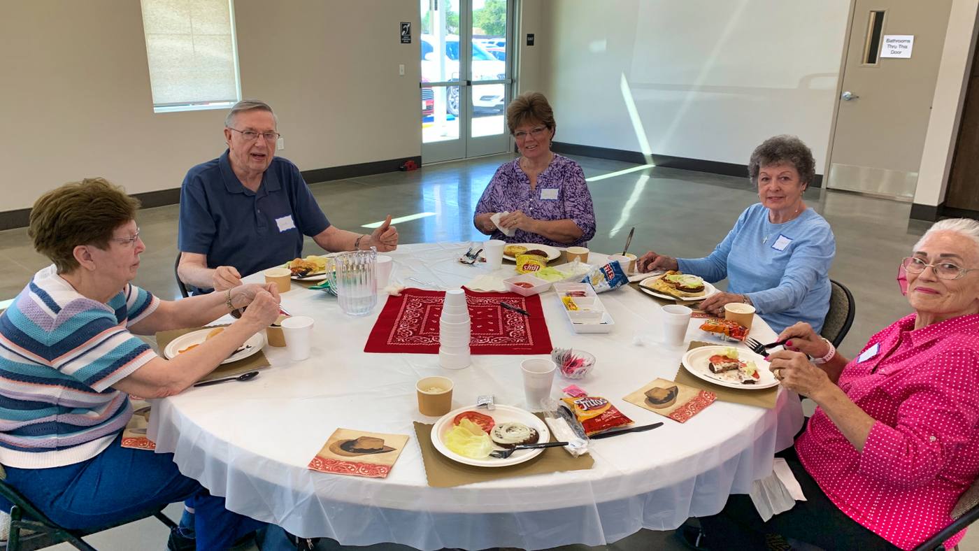 Senior adults sharing a meal at New Hope's monthly Senior Lunch
