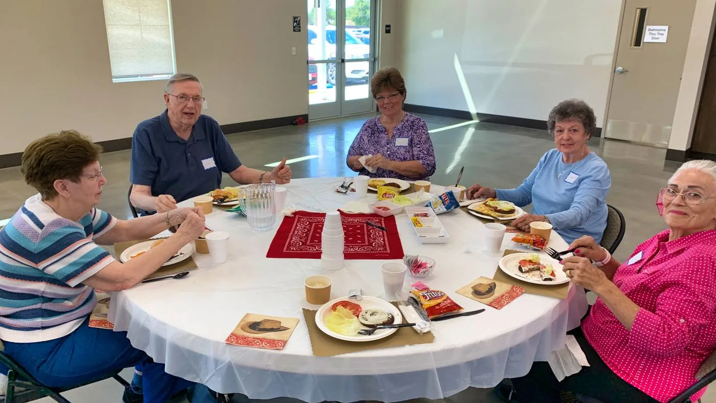 Senior adults sharing a meal at New Hope's monthly Senior Lunch