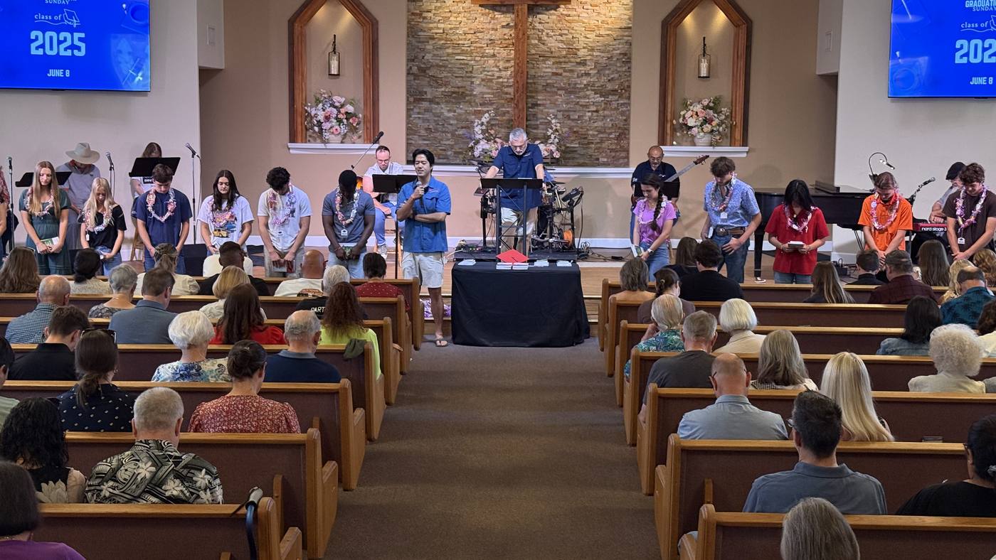 Adults gathered for teaching at New Hope, a leader at the front