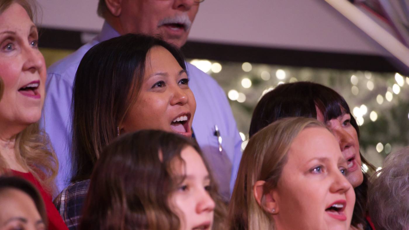 Young adults worshipping side by side during a New Hope service