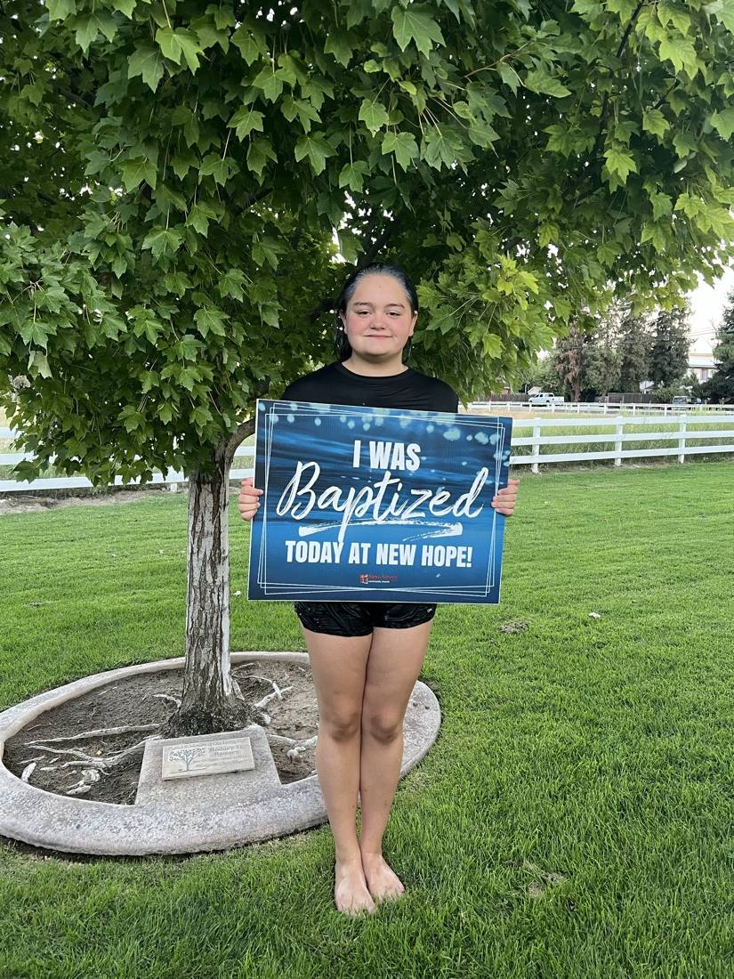 A young New Hope believer celebrating baptism