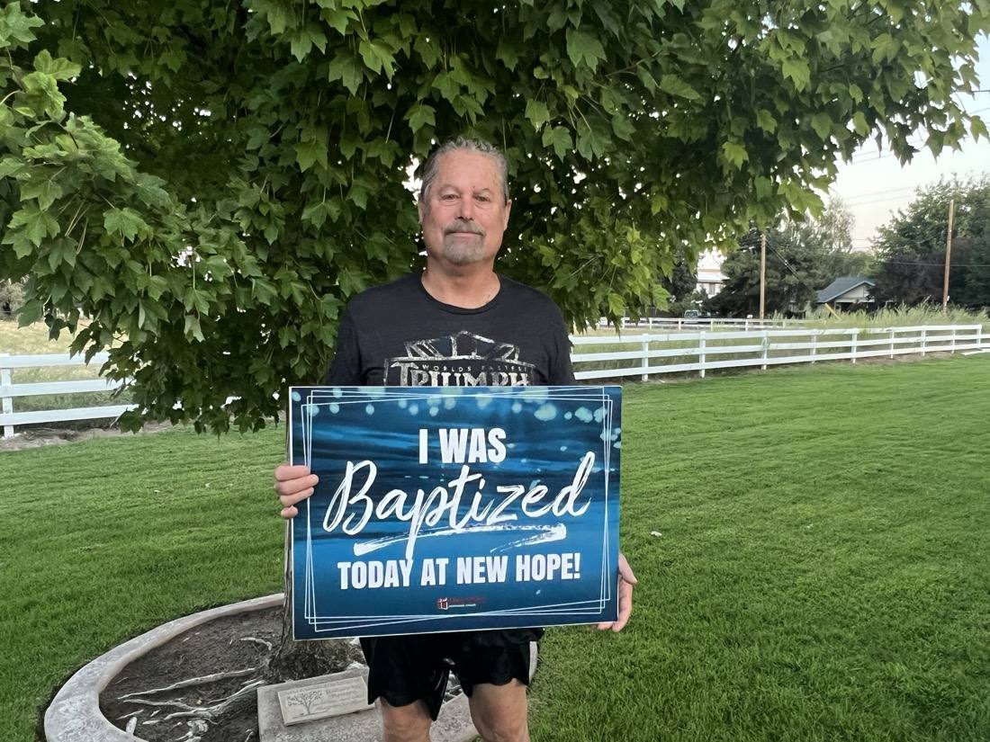 A New Hope member smiling after baptism on the church lawn