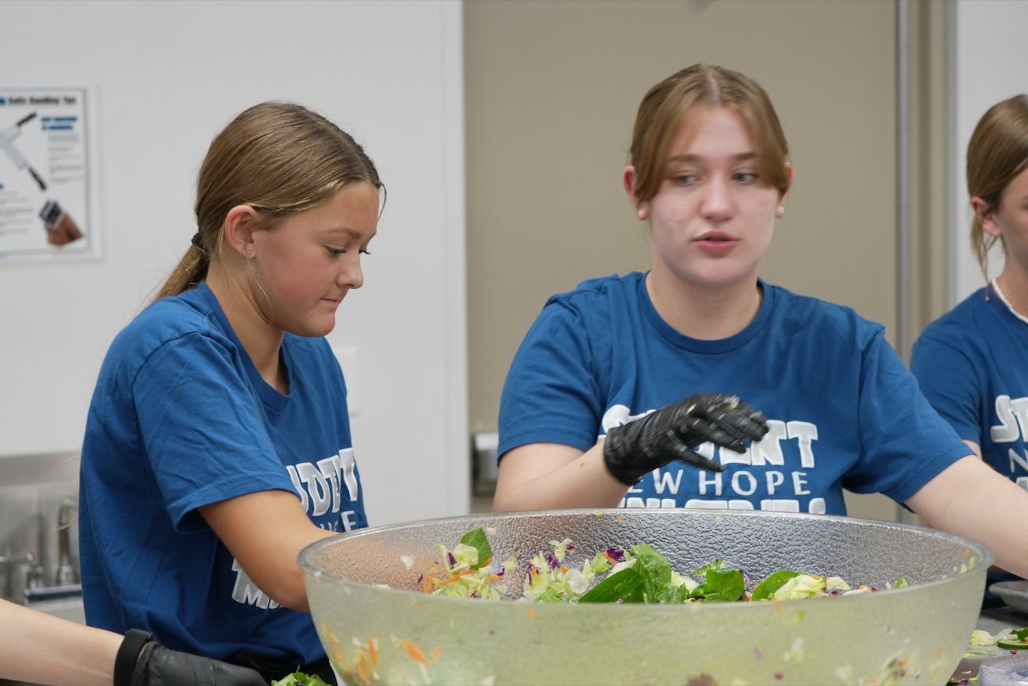 New Hope volunteers preparing a meal to share at a church gathering in Clovis