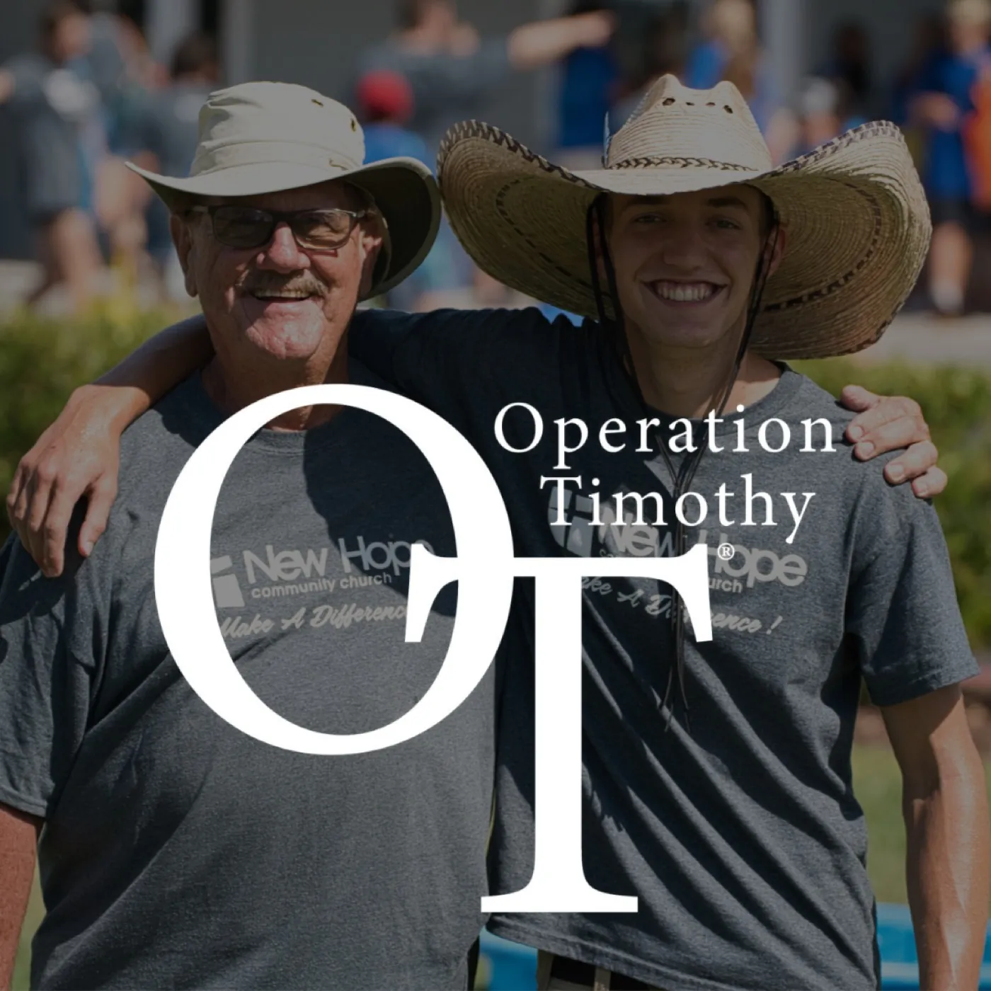 Operation Timothy: an older and a younger man in New Hope shirts, arm in arm