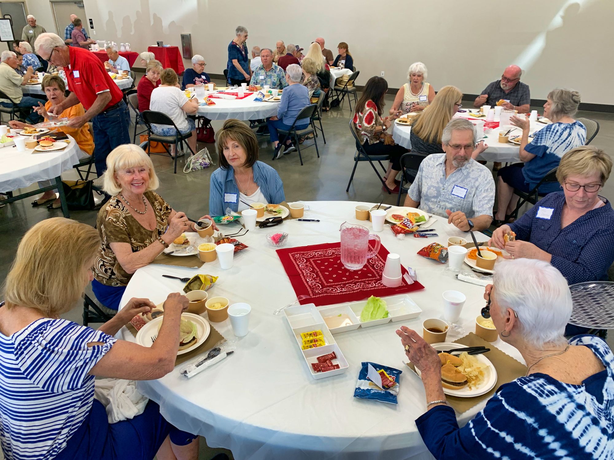 Members of the New Hope senior lunch gathered around tables in the fellowship hall over sandwiches and conversation