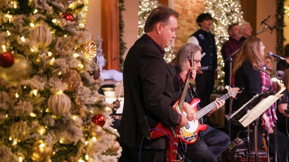 New Hope's worship band playing beside a lit, decorated Christmas tree