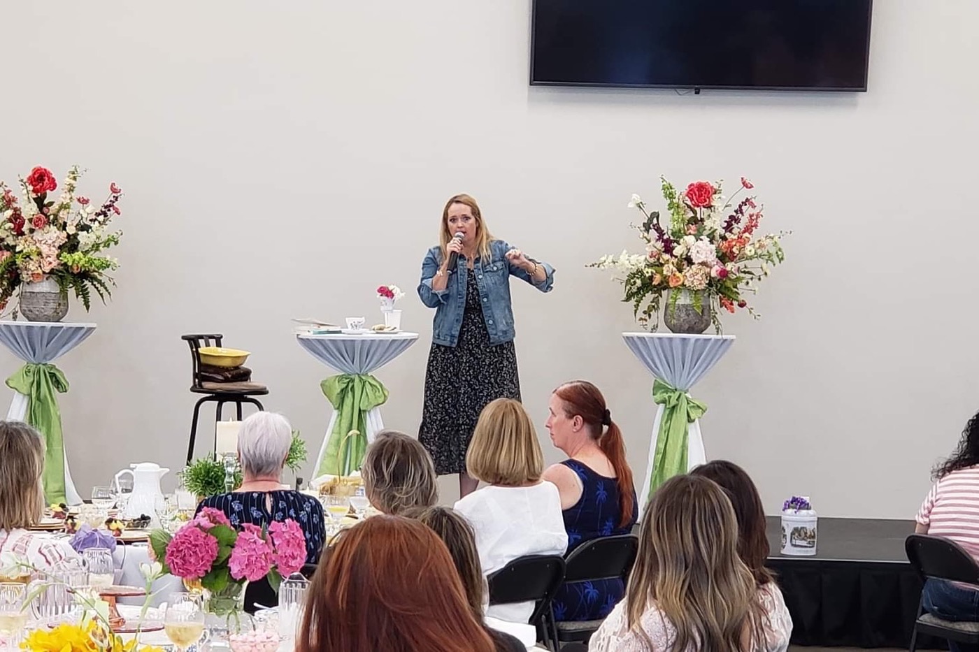 New Hope women gathered at tables decorated with spring flowers for a spring fellowship event