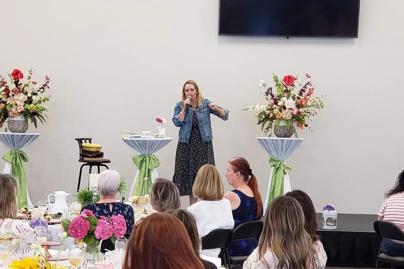 New Hope women gathered at tables decorated with spring flowers for a spring fellowship event