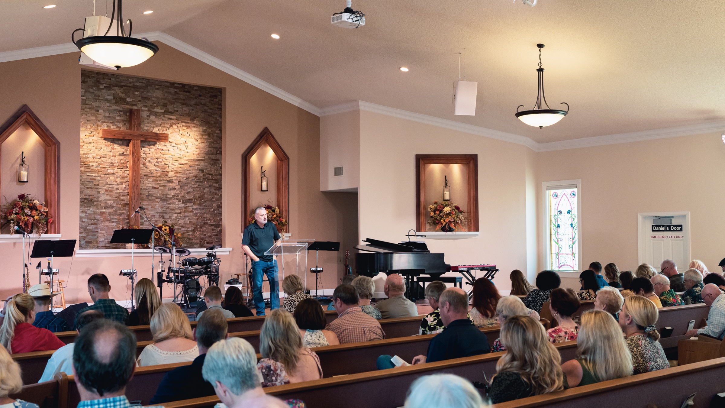 The sanctuary at New Hope Community Church in Clovis, with the wooden cross and stained glass