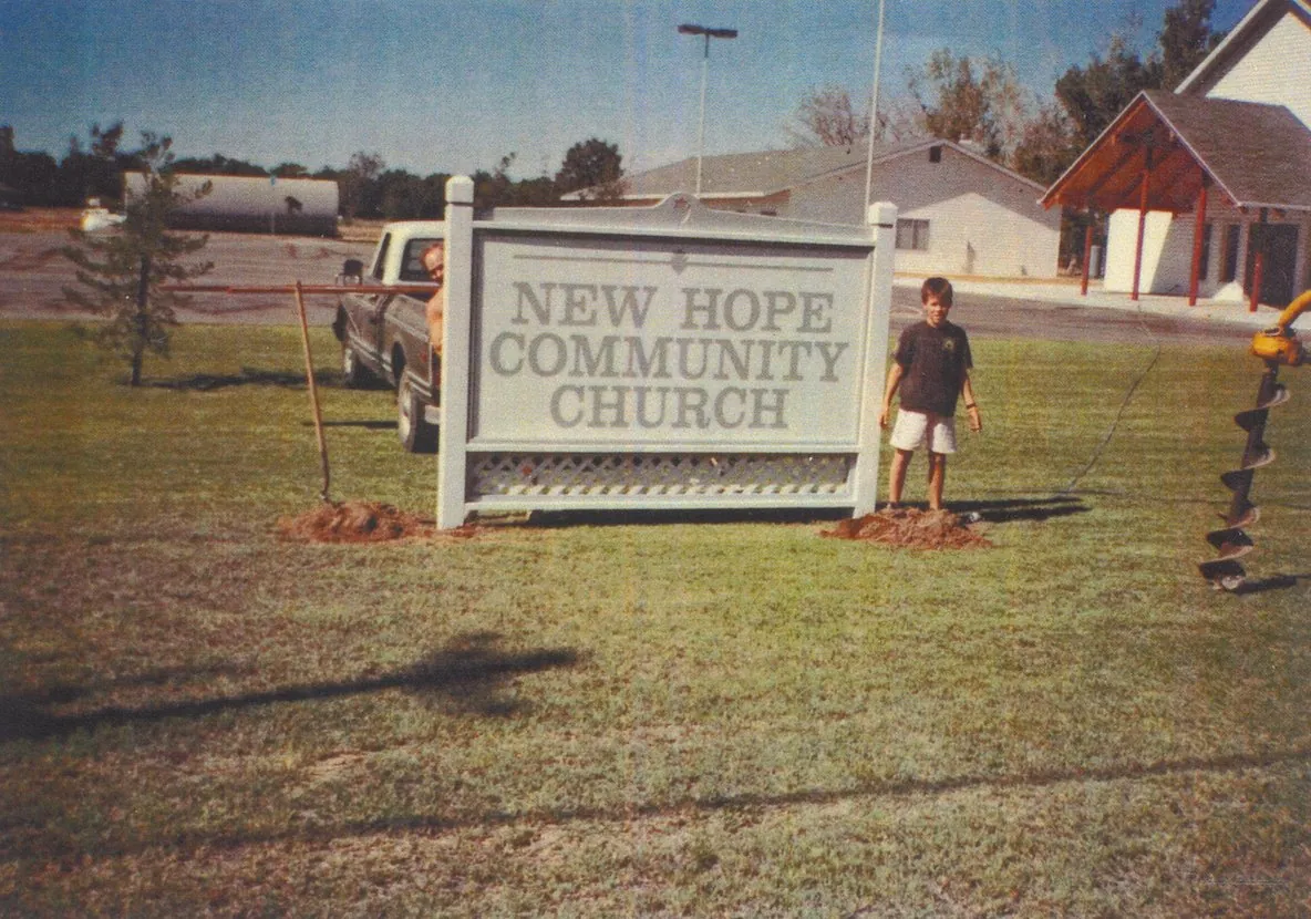 The New Hope Community Church sign at 4620 East Nees Avenue, with the sanctuary visible behind