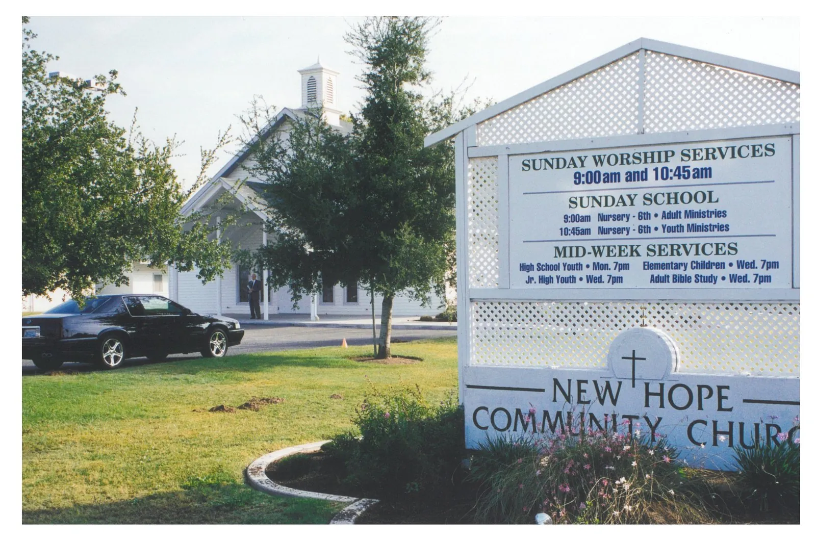 The New Hope Community Church sign and sanctuary, with worship service times posted