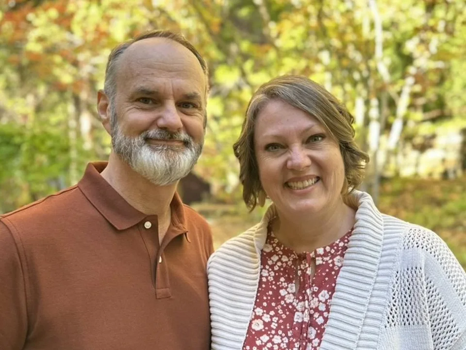 Matt and Shelley Actis smiling together outdoors.
