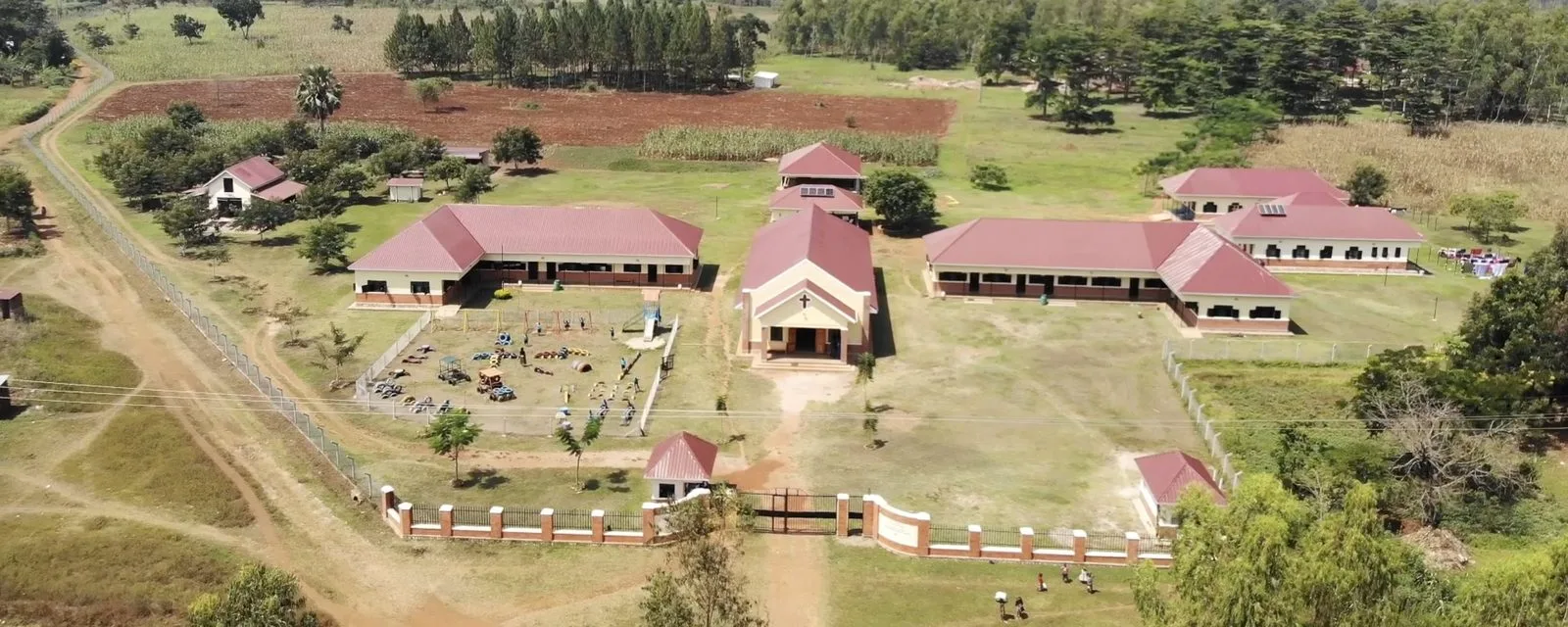 Aerial view of the red-roofed New Life campus in Bulesa, with its church, classrooms and farmland.