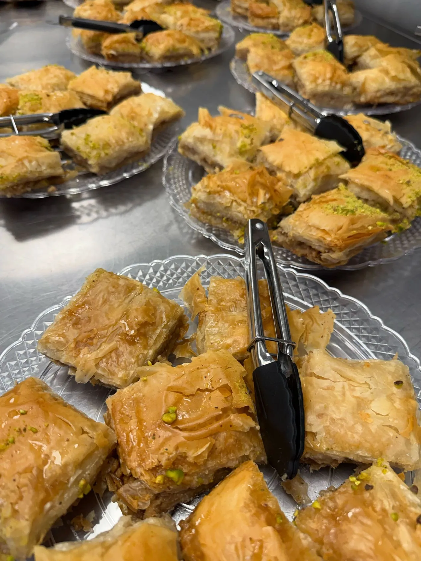 Trays of baklava dusted with pistachio, ready for dessert