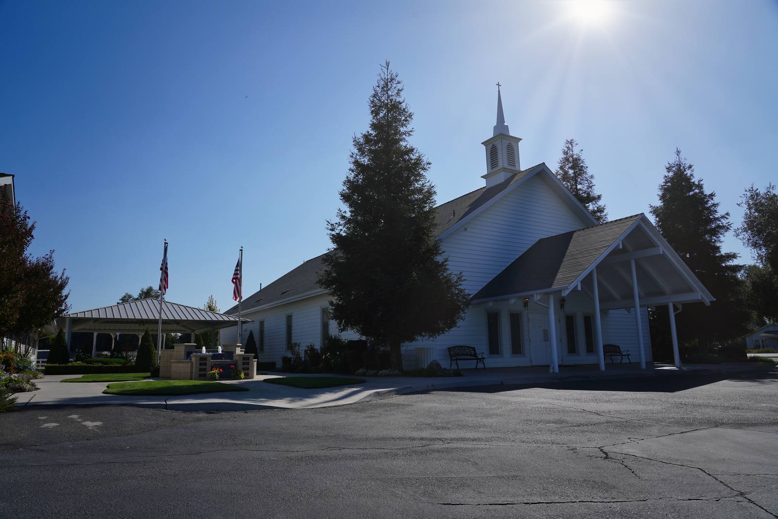 The New Hope Community Church building in Clovis on a clear morning, with the steeple and the pavilion