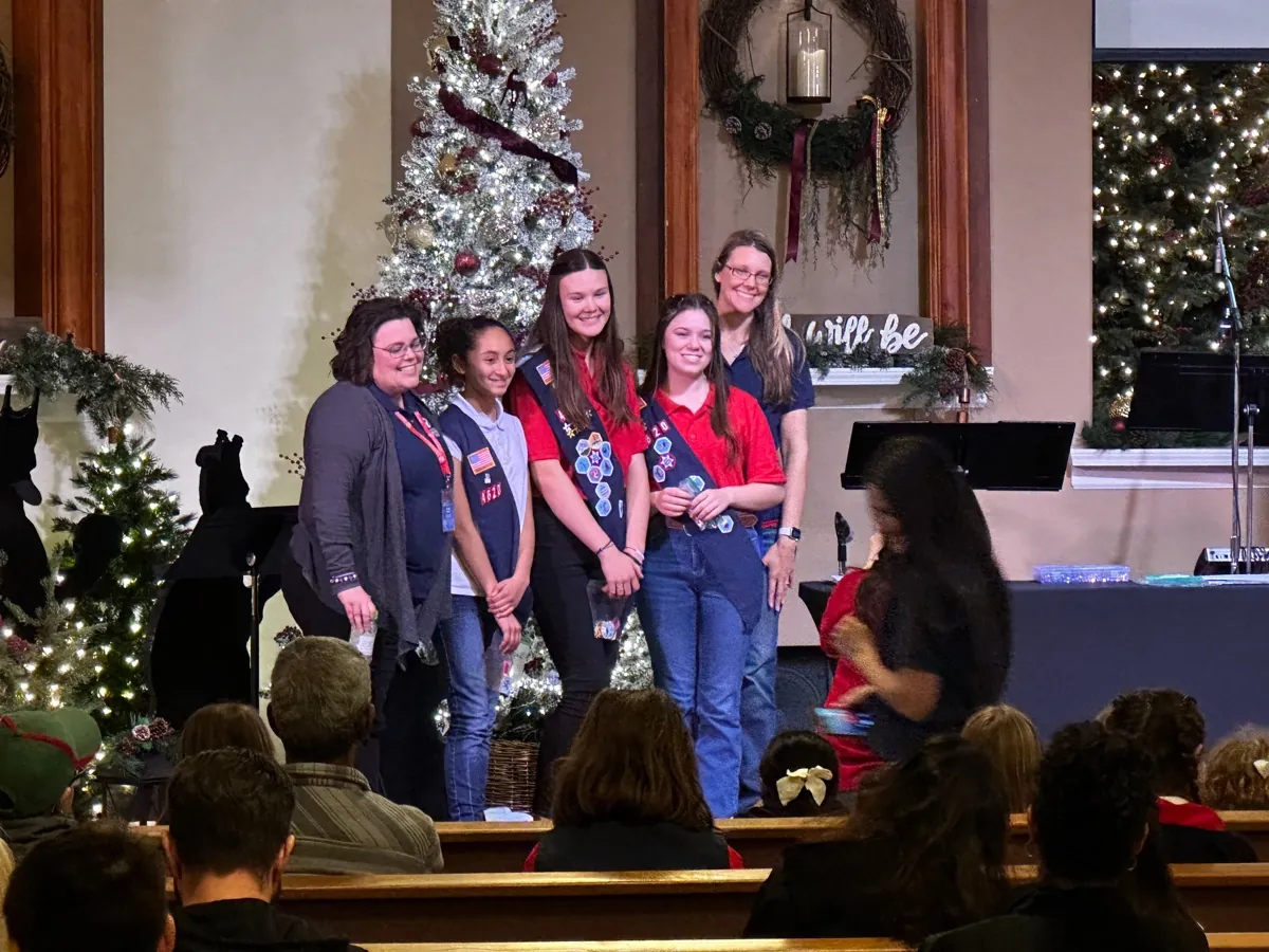 American Heritage Girls Troop CA-4620 leaders and members in sashes on the New Hope sanctuary stage
