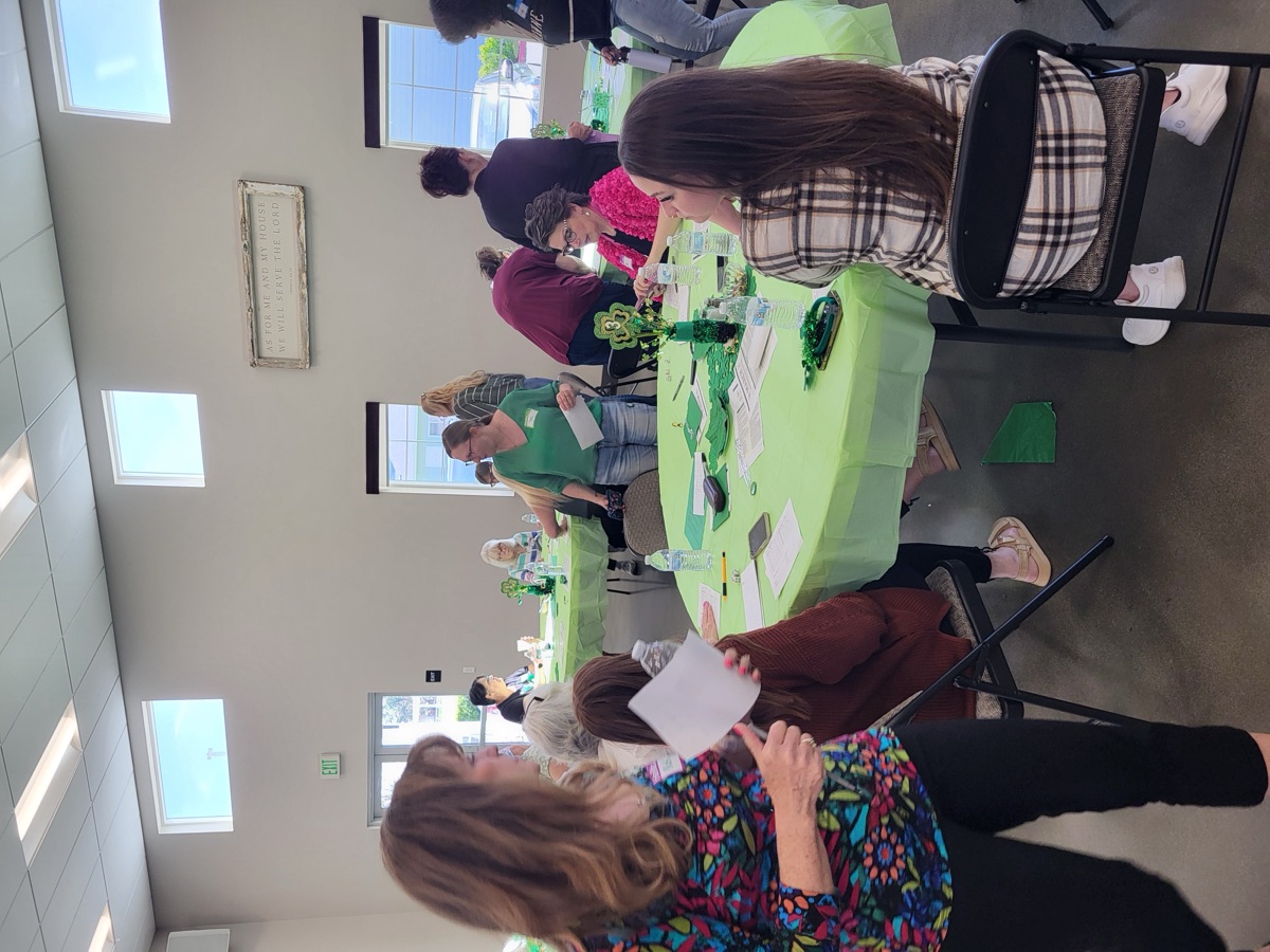 New Hope adults gathered around a table in fellowship