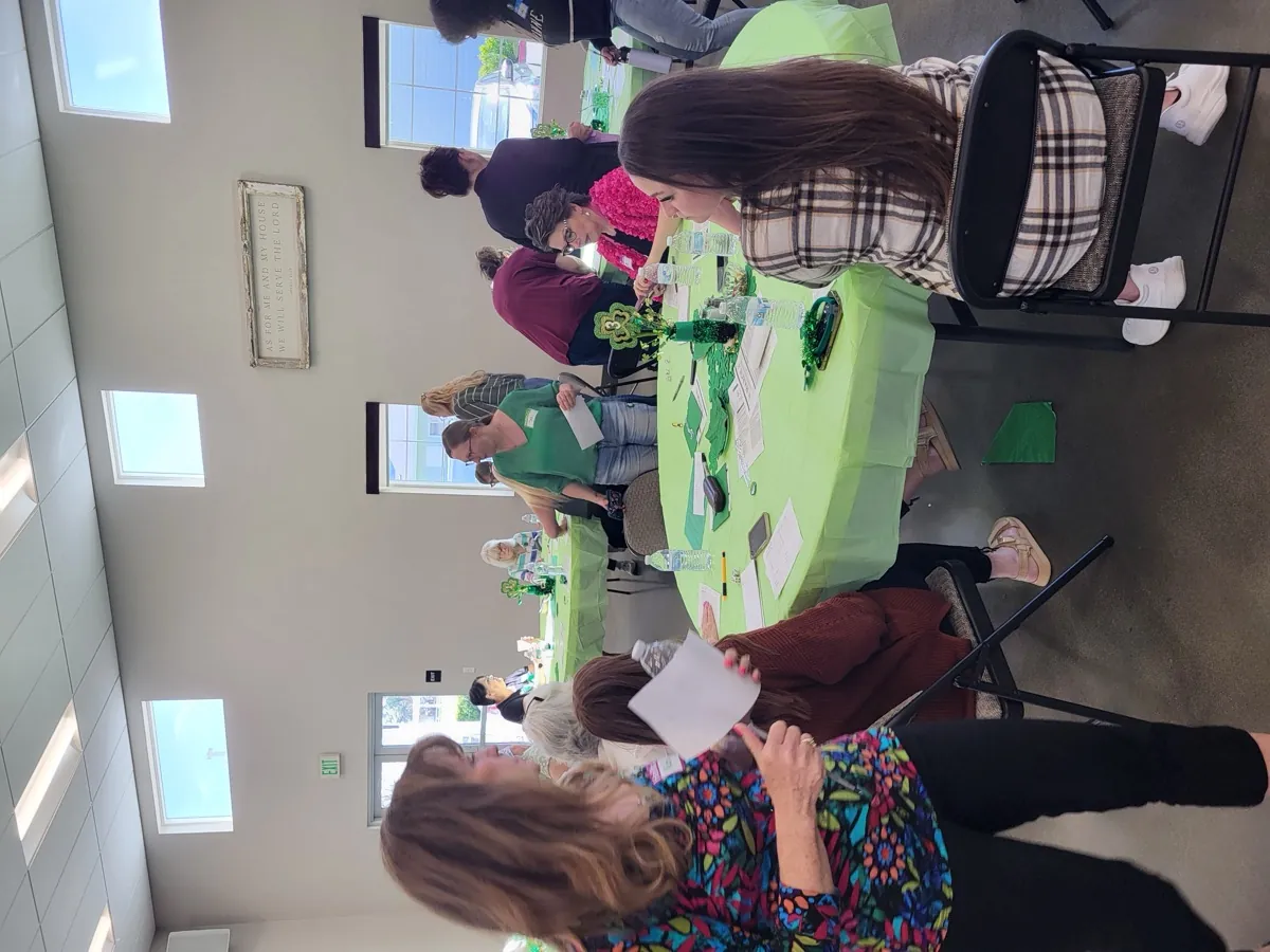New Hope adults gathered around a table in fellowship