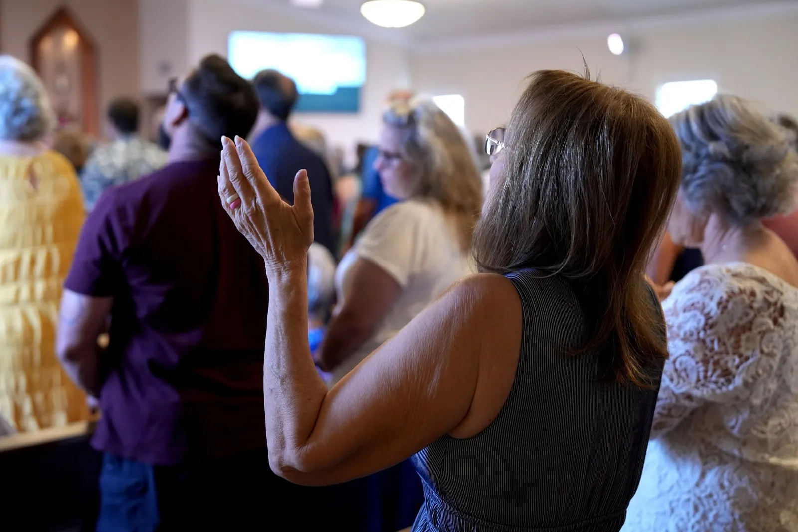 A woman in prayer during a Sunday service at New Hope in Clovis