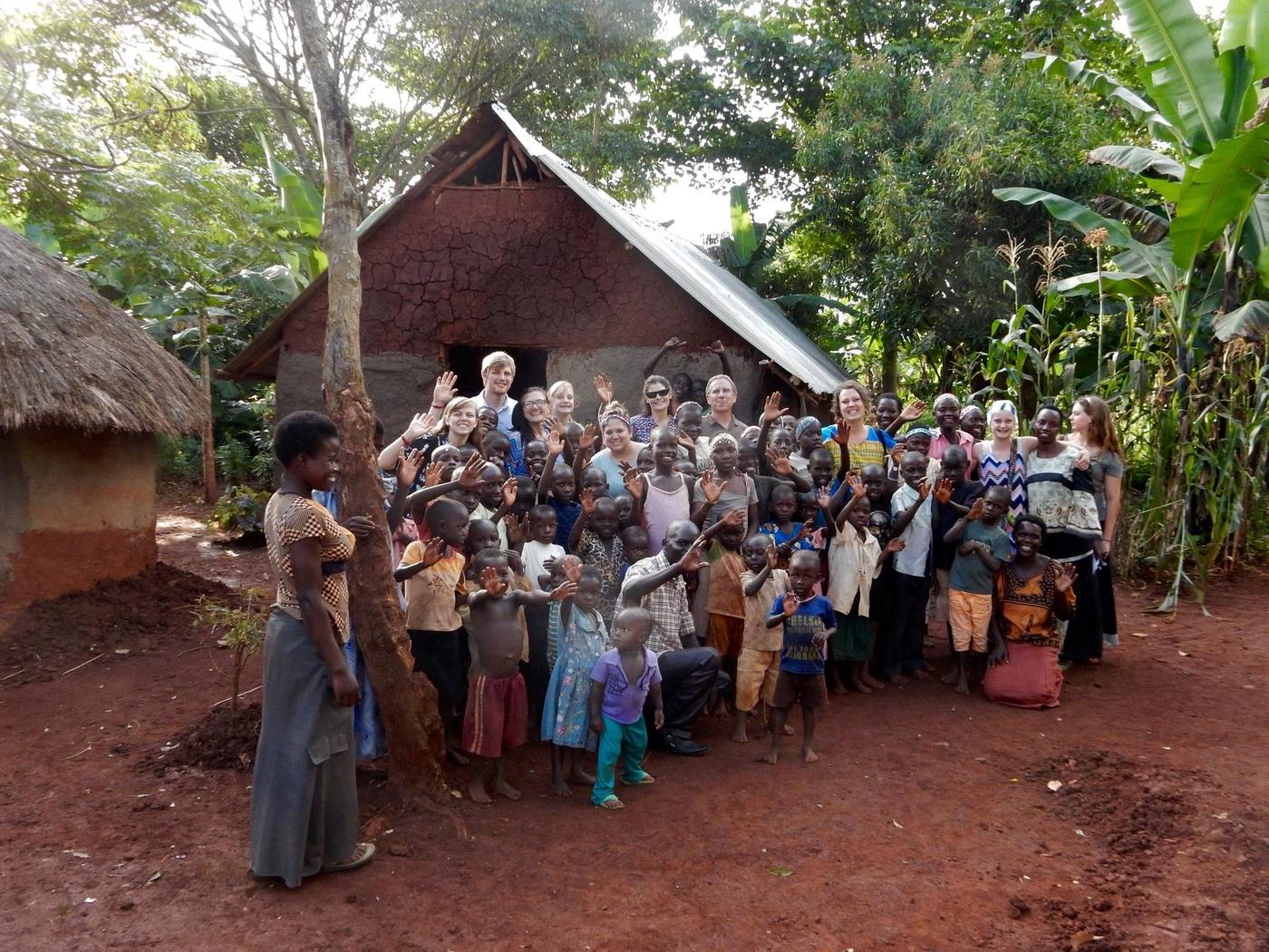A New Hope mission team standing with a large group of village children in Africa