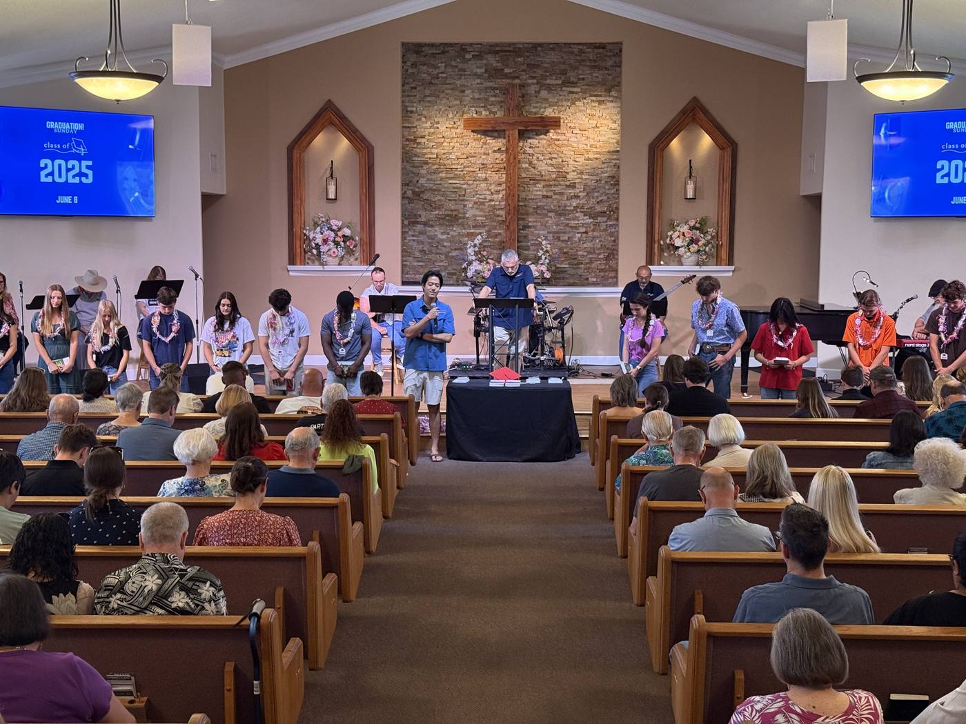 Graduates standing at the front of the New Hope sanctuary to be recognized