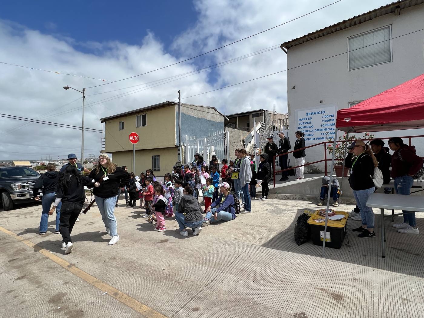 New Hope team members and local children at an outdoor outreach gathering in Mexico