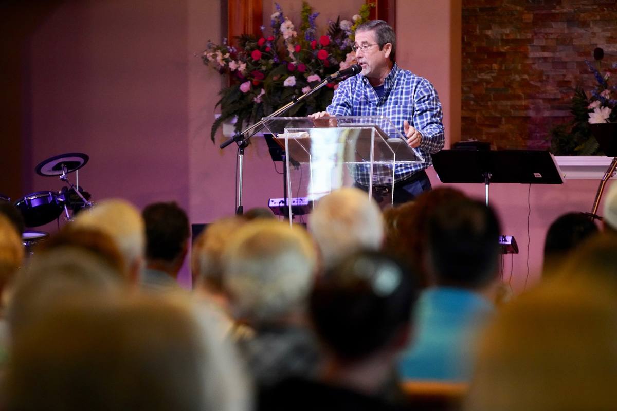 A pastor preaching from the pulpit over a full sanctuary at New Hope in Clovis