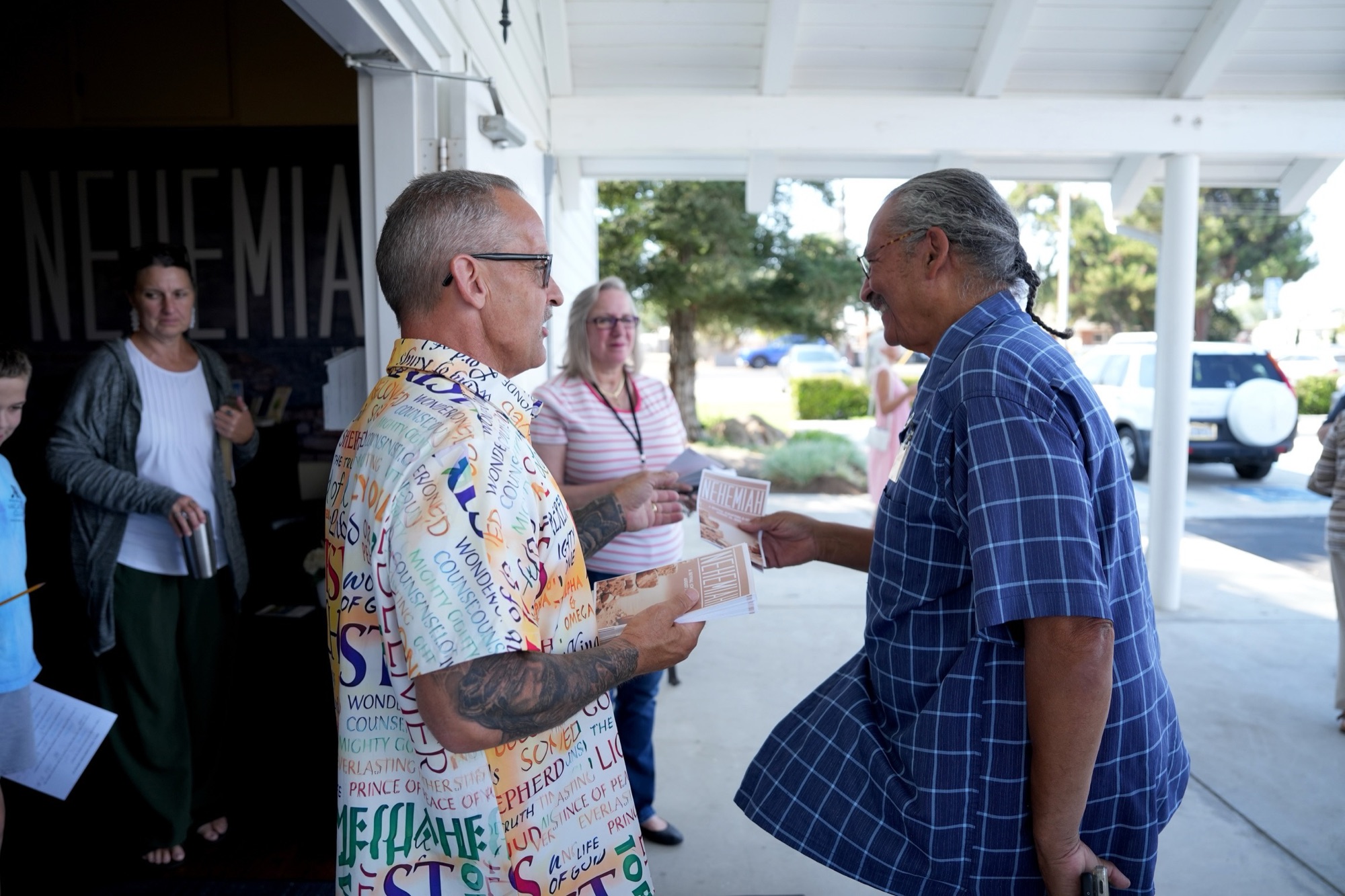 A New Hope member greeting another at the church door
