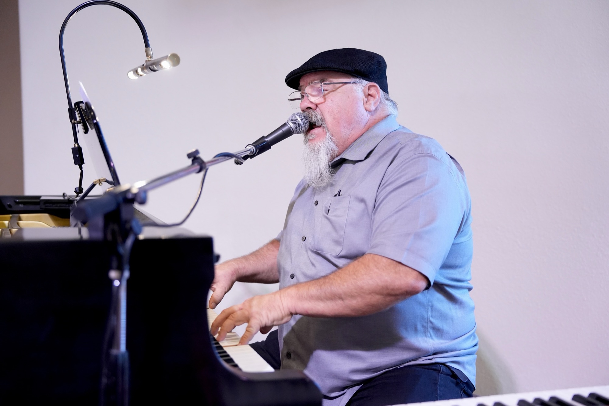 Worship leader playing piano and singing during a Sunday service at New Hope