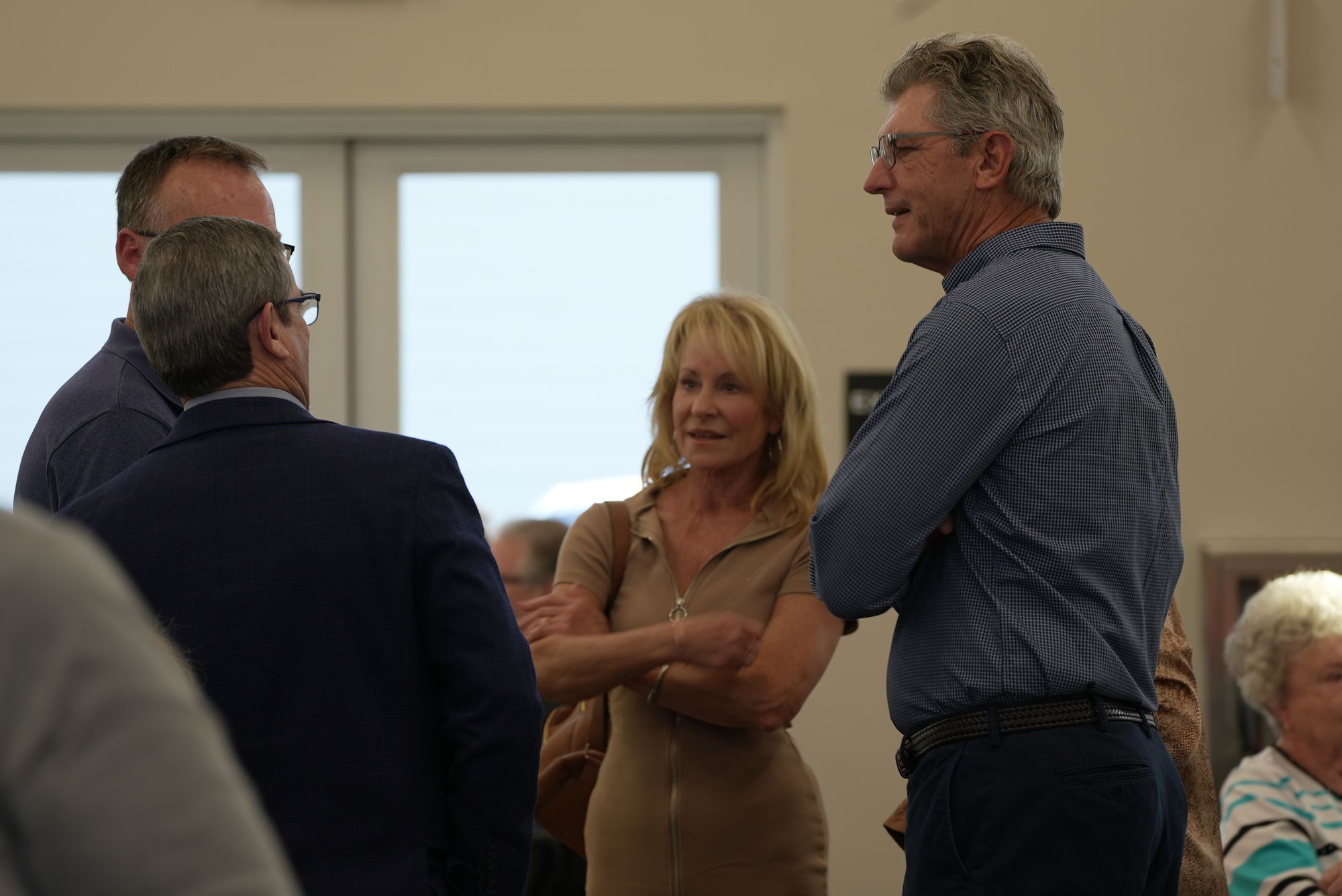 Four members of New Hope standing and talking together in the church lobby