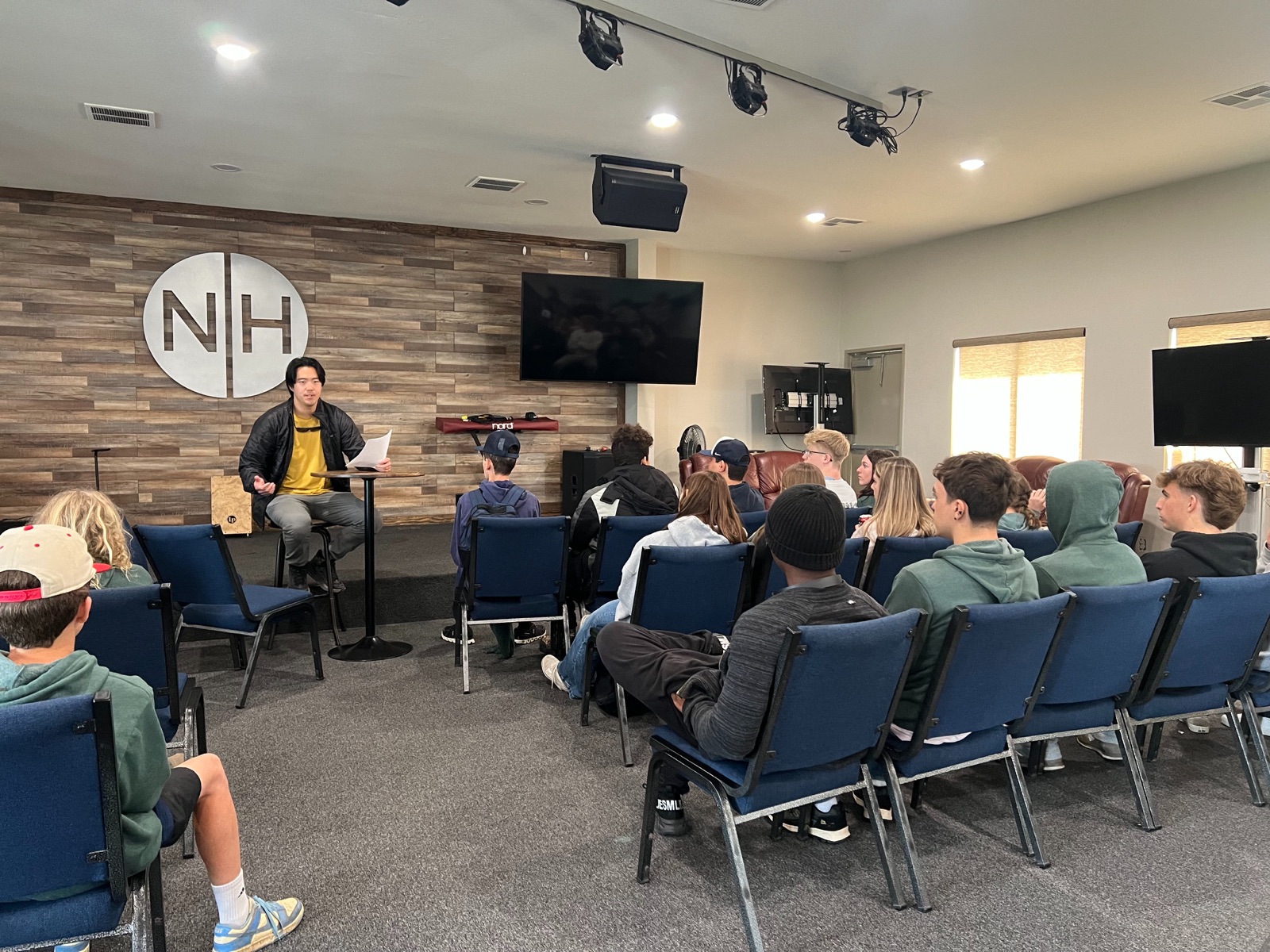 Ethan teaching a Sunday morning student gathering in the Bridge, students seated facing him