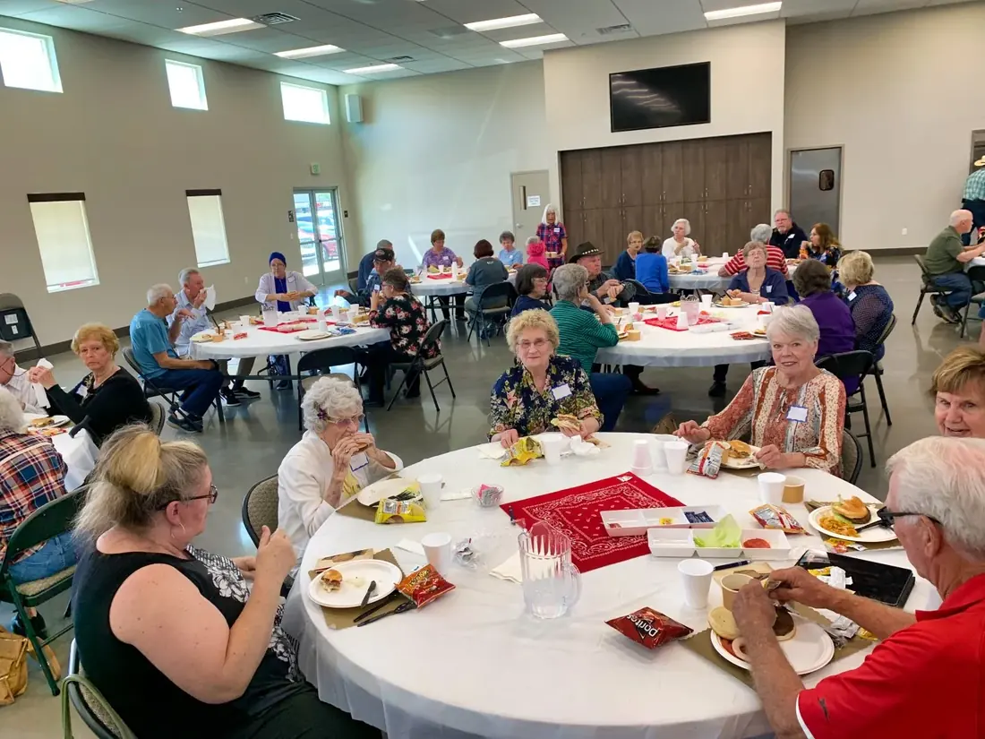 New Hope members in fellowship around a folding table after a small-group gathering