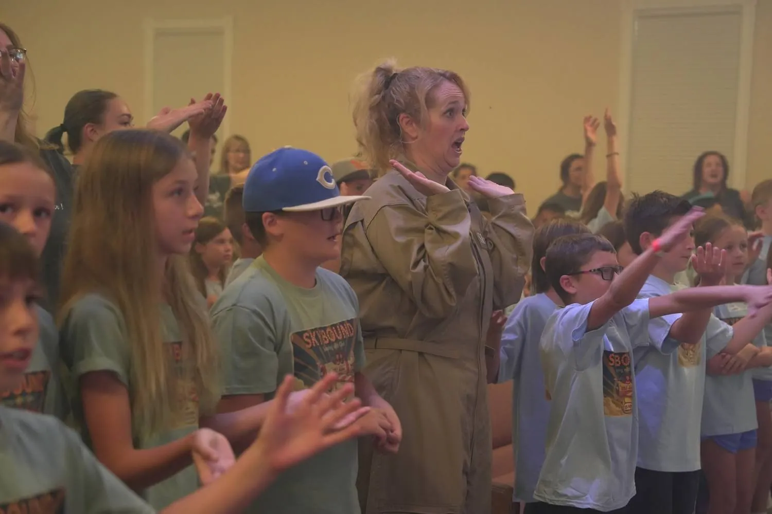 Cadets and a leader doing worship hand-motions together at Skybound