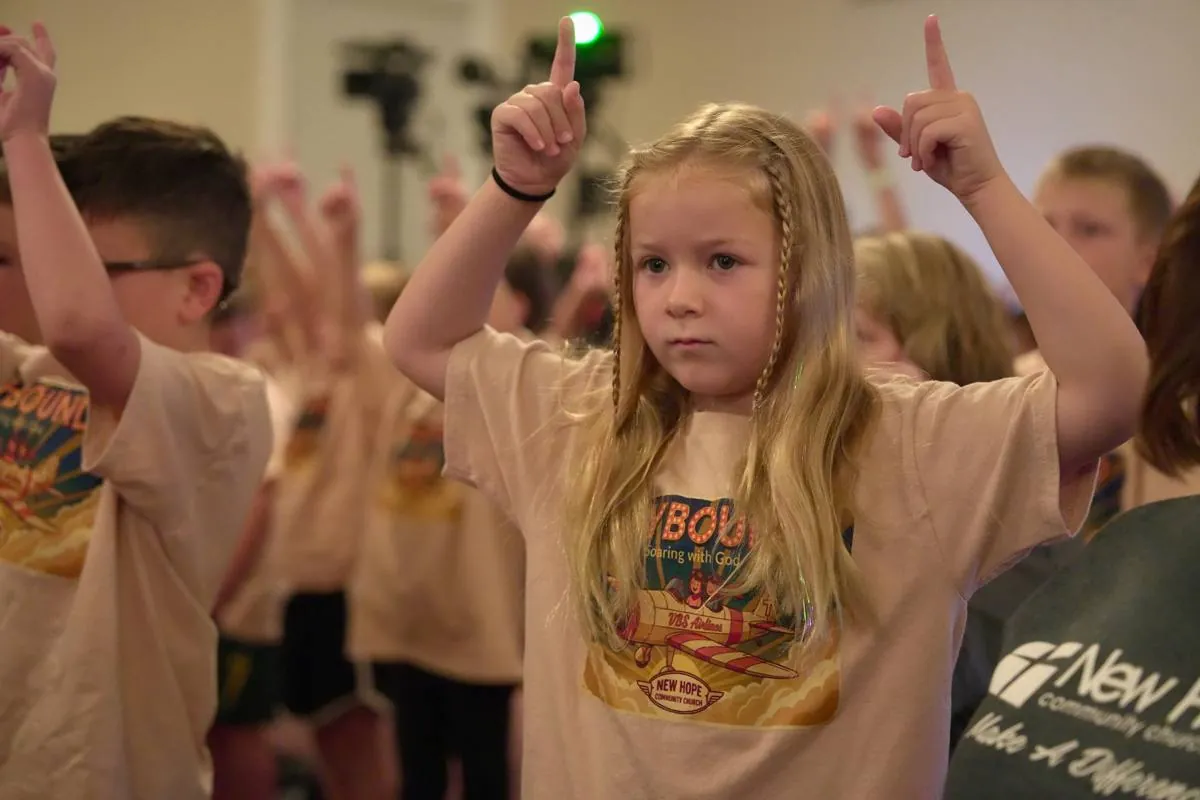 Skybound cadets worshiping with hands raised