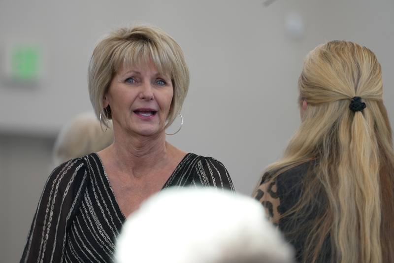 Two New Hope members catching up in conversation at a church gathering