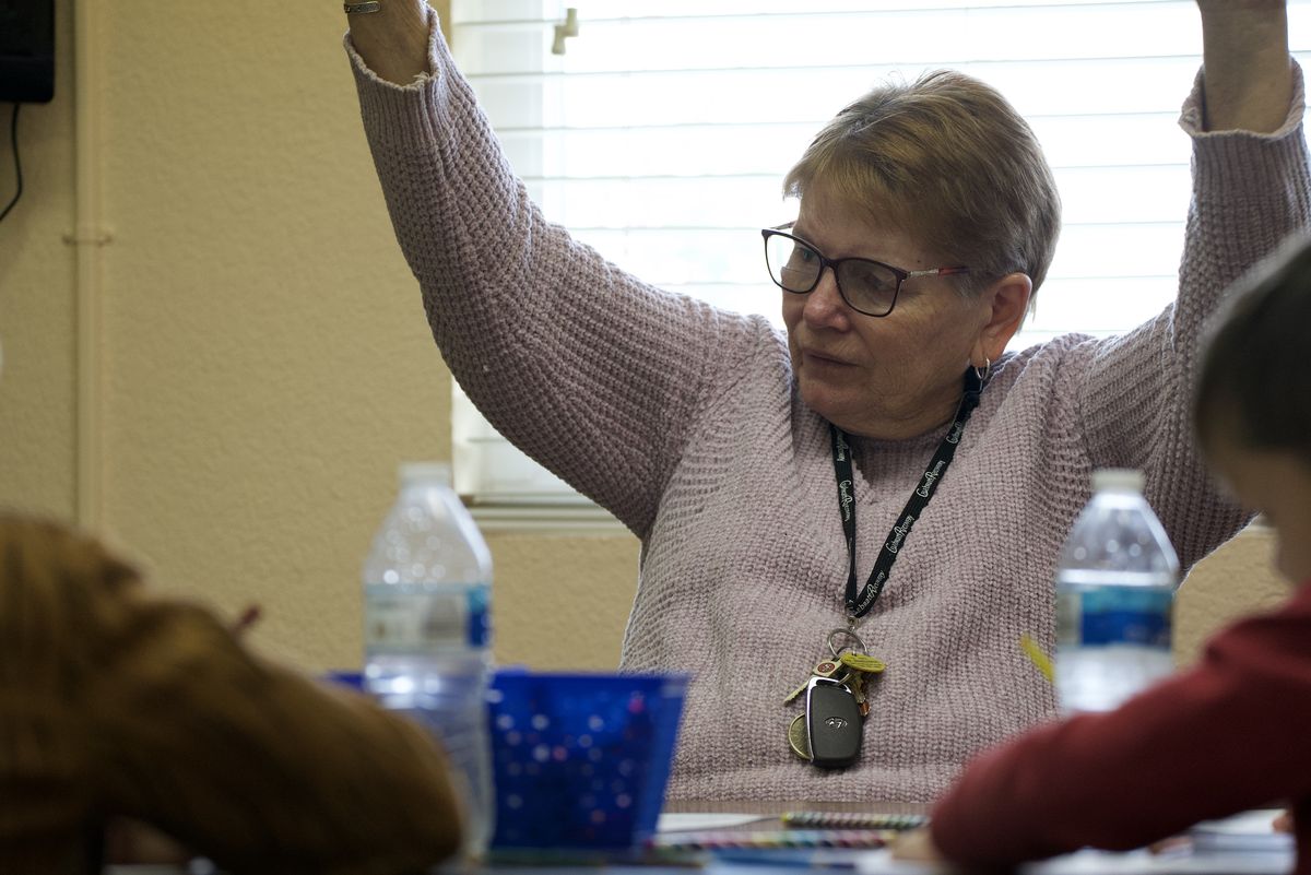 A New Hope Sunday school teacher engaging kids at a craft table