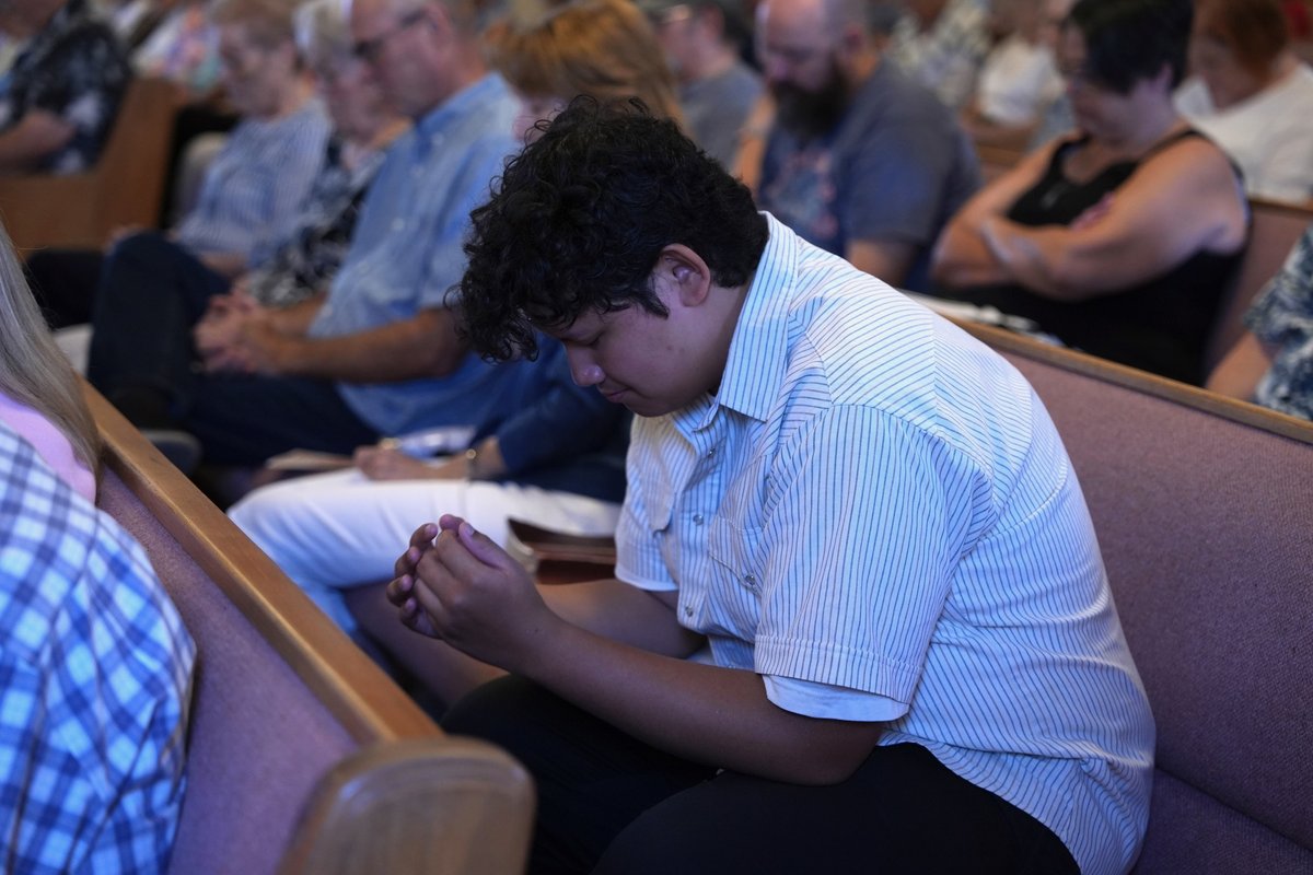 A young man in quiet prayer at New Hope