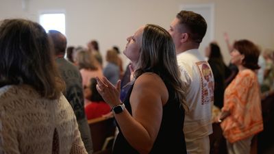 A New Hope member worshipping during a Sunday morning service