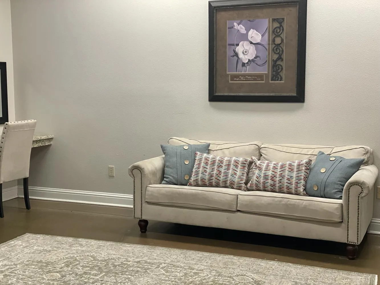 The bridal room with a sofa, pillows, mirror, and seating