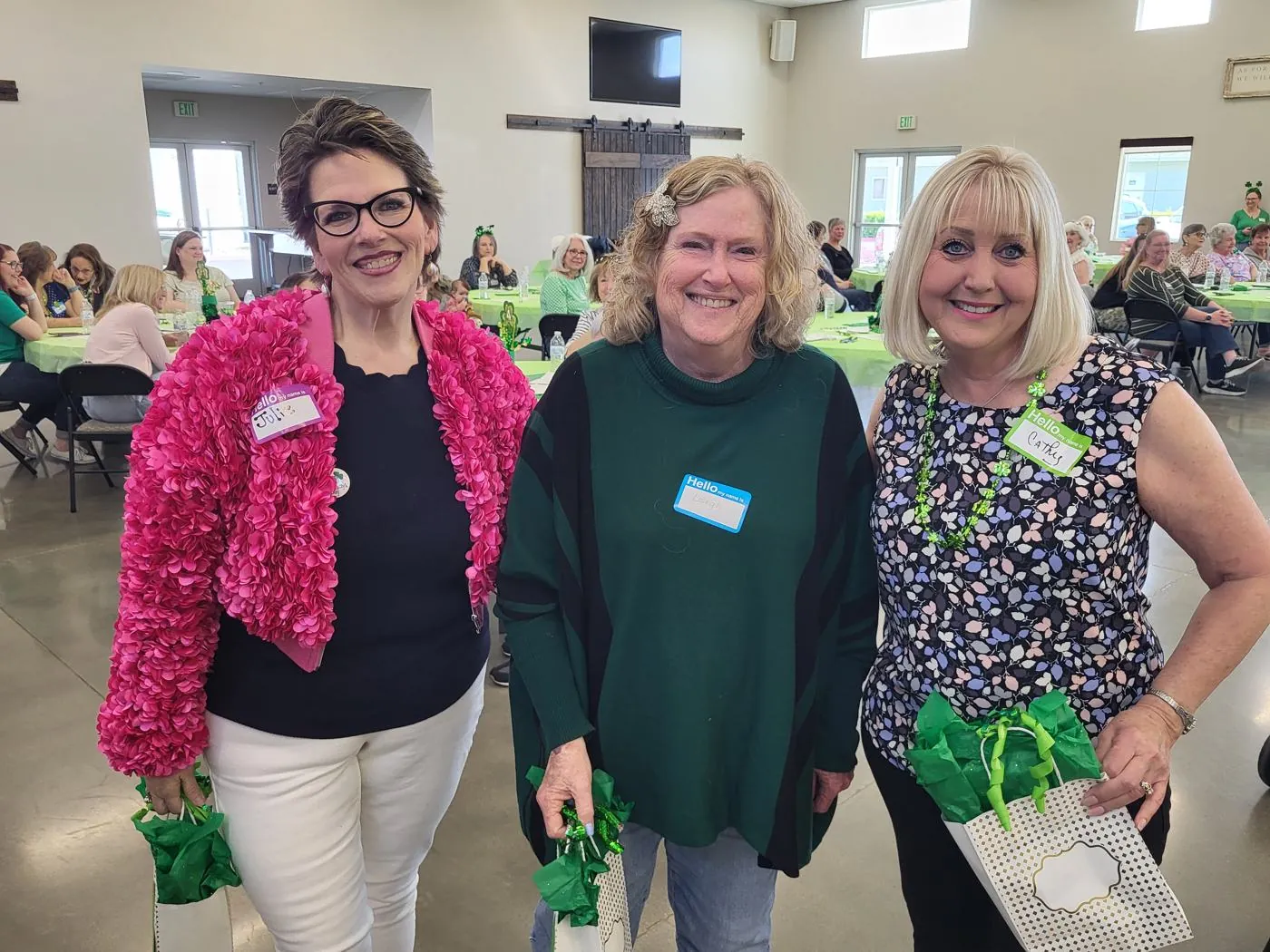 Three women smiling together at a New Hope women's Bunco afternoon in Clovis