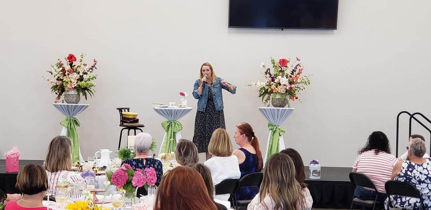 Women of New Hope gathered with flowers on the tables for a women's ministry luncheon in Clovis